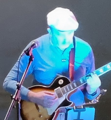 Sasha Ovsankin playing guitar on stage